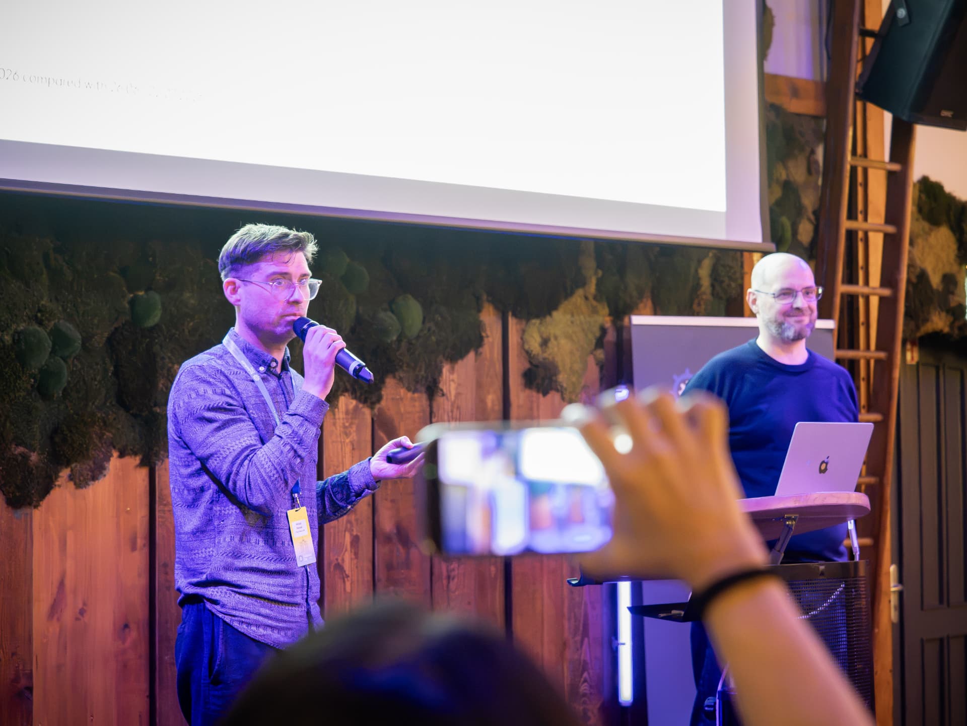 Two speakers on stage answering questions at KubeAuto Day Berlin