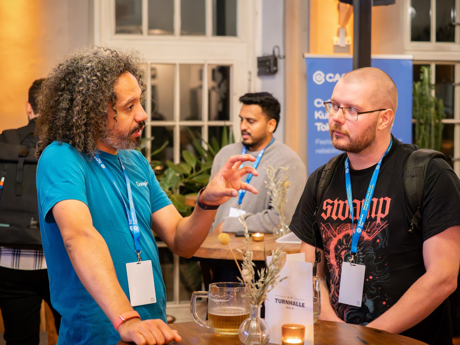 Attendees networking with drinks at the Alte Turnhalle bar
