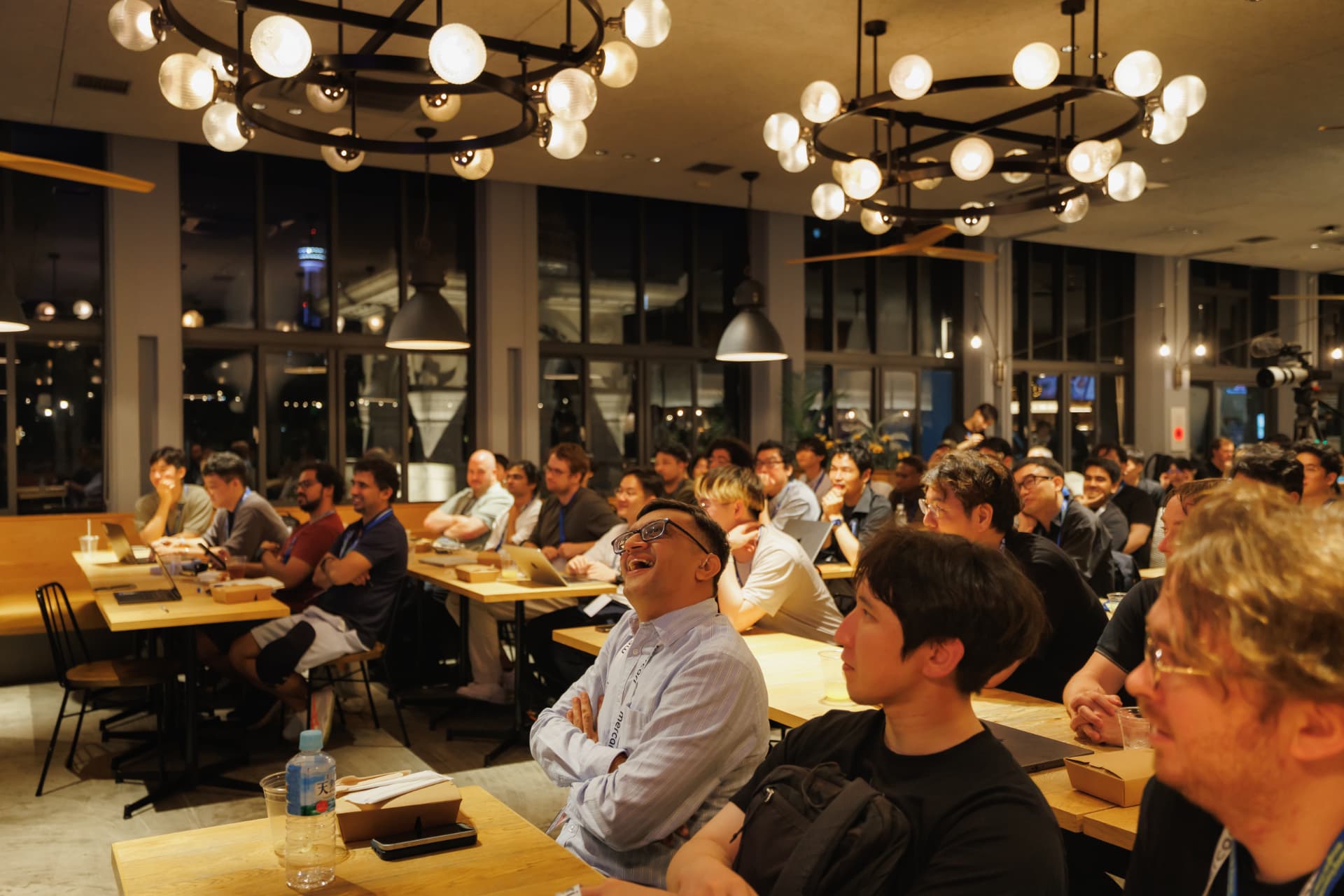 Attendees laughing during a talk at KubeAuto Day Japan